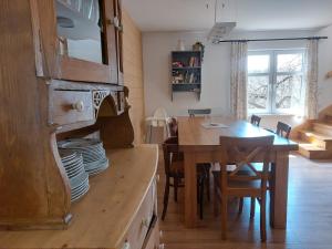 a kitchen with a table and a dining room at Beztroska Chata Bieszczady in Mchawa