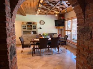a kitchen and dining room with a table and chairs at Ošupynė in Šventoji