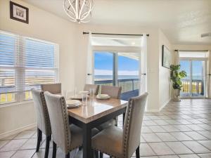 a dining room with a table and chairs at Oceanside Paradise in Galveston