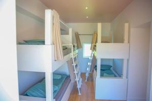 a room with three bunk beds in a room at La Vallee 