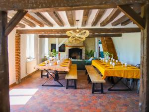 的住宿－La Vallee，一个带桌子和壁炉的大型用餐室