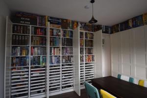 a room with a book shelf filled with dvds at Hotel Sonnenschein - Spielerei im Sonnenschein in Dahme