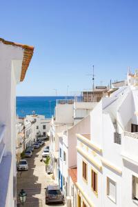 a view of a street in a town with the ocean at Casa Clementina in Albufeira