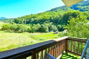 a balcony with a view of a field and mountains at Appartement de 2 chambres avec balcon amenage et wifi a Courchevel a 6 km des pistes in La Perrière