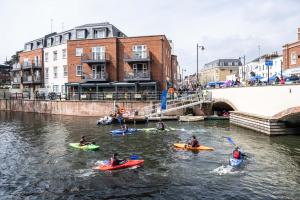 a group of people kayaking down a river at Super Vibrant 2 Bedroom With Parking in Maidenhead