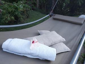 a group of towels sitting on top of a hammock at L' authentique in La Trinité