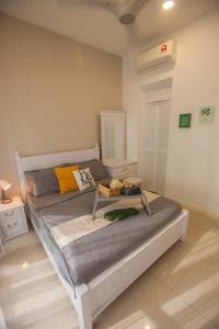 a bedroom with a bed with a table on it at D'Pristine Medini By The one - 8min walk to Legoland in Nusajaya