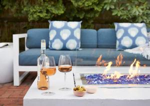 a bottle of wine and two glasses on a table at The Christopher, The Edgartown Collection in Edgartown