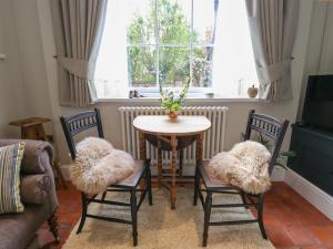 a living room with a table and chairs and a window at Hangmans cottage in Horncastle
