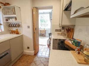 a kitchen with a door open to a dining room at Hangmans cottage in Horncastle