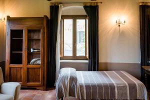 Postel nebo postele na pokoji v ubytování Agriturismo Bio Fattoria di Pietra