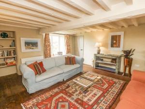 a living room with a couch and a fireplace at Langstone Farm in Okehampton