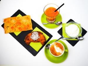 a table with plates of food and a drink at Hotel Dell'Orto in Chiavari