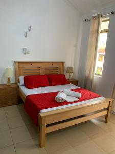 a bedroom with a bed with two towels on it at Selah Holiday Apartment at Sebuleni Nyali in Mombasa