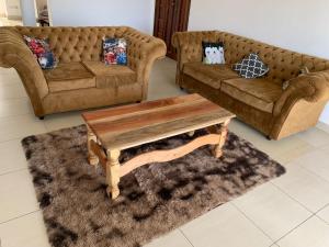 a living room with two couches and a coffee table at Selah Holiday Apartment at Sebuleni Nyali in Mombasa