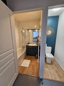 a bathroom with a toilet and a tub and a sink at T2 Saint Jean de Luz 200m plage in Saint-Jean-de-Luz