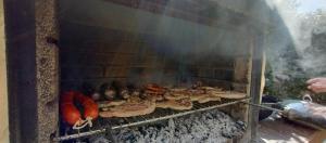 a grill with a bunch of food cooking on it at HOTEL RURAL LA ENGAÑA in Pedrosa
