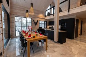 a large dining room with a long table and chairs at Villa Levilla, luxury in Levi in Levi