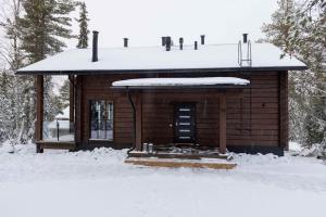 a small cabin with snow on top of it at Villa Levilla, luxury in Levi in Levi