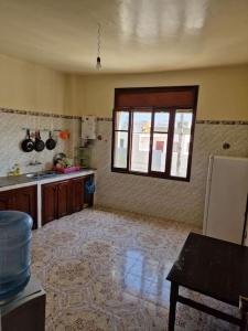 a kitchen with a sink and a window in a room at Large Family Apartment by Beach & center of town in Asilah