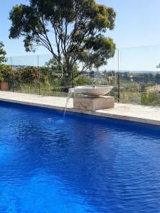 a fountain in the middle of a swimming pool at Angaston Lodge in Angaston