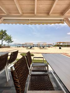a table and chairs on a patio with the beach at Crystal Blue in Potos