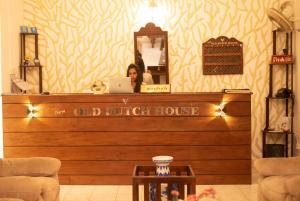a woman sitting at a counter with a laptop at New Old Dutch House - Galle Fort in Galle