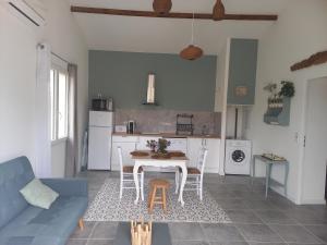 a kitchen and living room with a table and chairs at L'EN HAUT in Aramon +26 photos