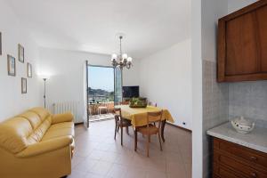 a kitchen and dining room with a table and a couch at Bagetti in Varazze