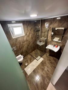 a bathroom with a shower and a toilet and a sink at Crystal Blue in Potos