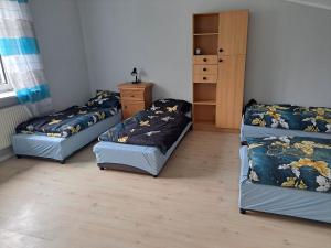 a room with two beds and a dresser in it at Gorzów Wielkopolski Szarych Szeregów 1 wolne Pokoje/kwatery in Gorzów Wielkopolski