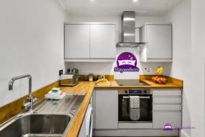 a small kitchen with a sink and a counter top at Clarabel Studio Apartment - Stayseekers in Salisbury