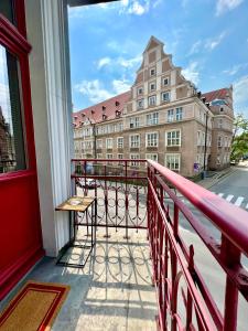 a balcony with a view of a building at Red&Yellow Apartments Centrum in Olsztyn