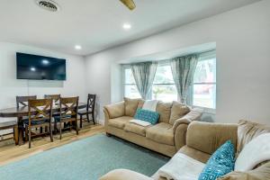 a living room with a couch and a dining room at Pet-Friendly Cocoa Beach Vacation Rental! in Cocoa Beach