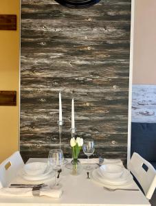 a dining table with white plates and candles on it at Flower house 1 in Sofia