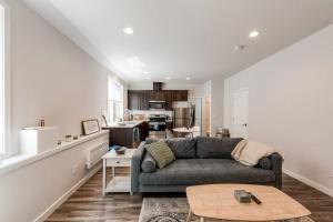 a living room with a couch and a kitchen at Walkable Apt Next to Restaurants, Bars, and Shops! in Portland