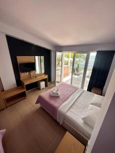 a bedroom with a bed and a view of the ocean at Crystal Blue in Potos