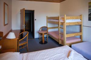 a room with two bunk beds and a desk at Penzion Diana in Železná Ruda +162 photos