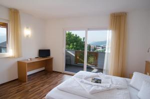 Postel nebo postele na pokoji v ubytování Garni Hotel Peterlinhof