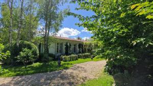 an exterior view of a white house with trees at Caserta in Hondarribia