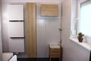 y baño con lavabo y ducha con azulejos blancos. en HOME 2201, en Gerasdorf bei Wien