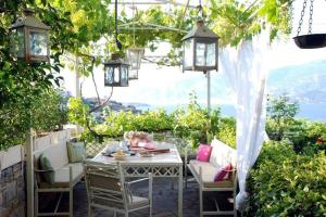 an outdoor patio with a table and chairs and lights at Evelina - Home with View in Volos