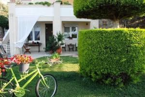 a green bike parked in front of a house at Evelina - Home with View in Volos