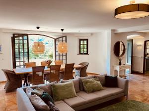 a living room with a couch and a table at Beautiful stone house with fabulous pool and outdoor kitchen in Auribeau-sur-Siagne