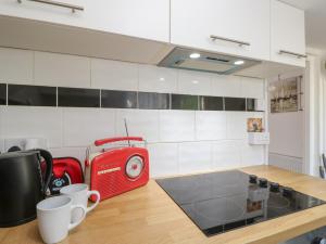 a kitchen with a red toaster and cups on a counter at Castle Cottage in Newport +19 photos