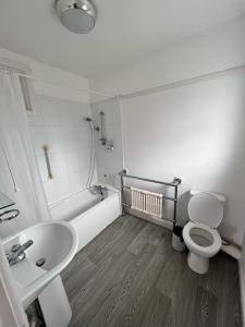 La salle de bains est pourvue de toilettes, d'un lavabo et d'une baignoire. dans l'établissement Born Park, à Bournemouth