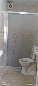 a white bathroom with a toilet and a shower at Bereket traveler Hotel in Istanbul