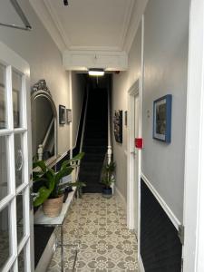 a hallway with a staircase with potted plants at Rooms at 153 ROOM ONLY in Scarborough