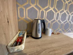 a coffee pot and a basket on a table at Pasja Noclegi B&B in Wołów