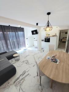 a living room with a table and a couch at Flumine in Rijeka